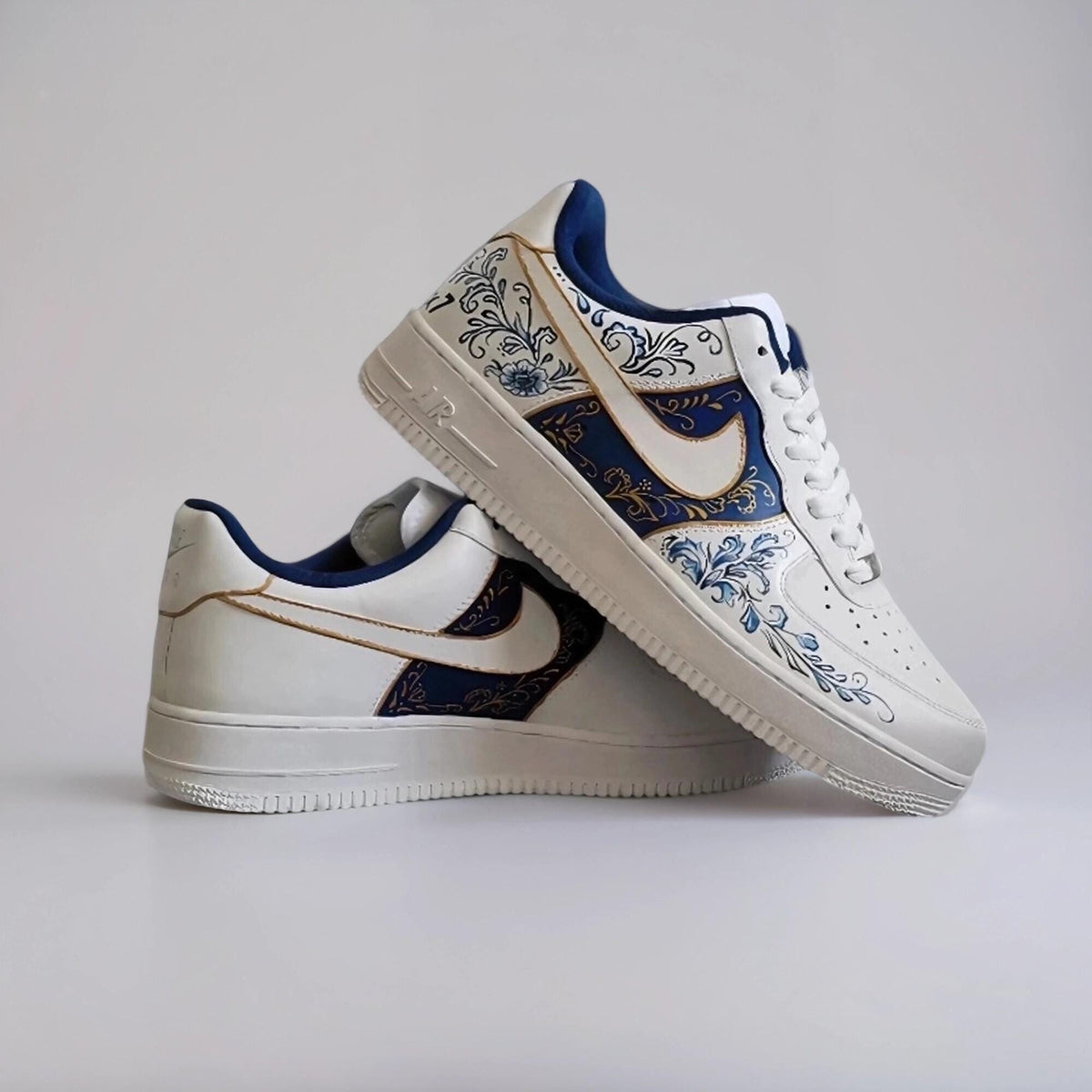 Custom-made white Gzhel- style sneakers, hand-painted with blue floral filigree and gold, a one-of-a-kind gift for AF1 sneakers